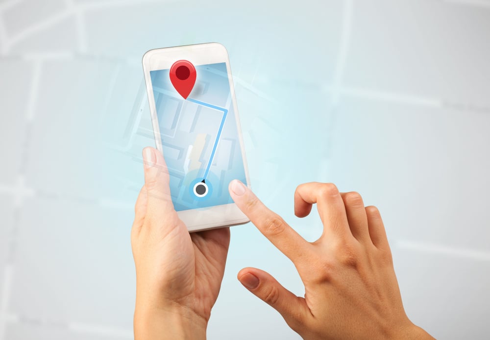 Female fingers touching smartphone with map